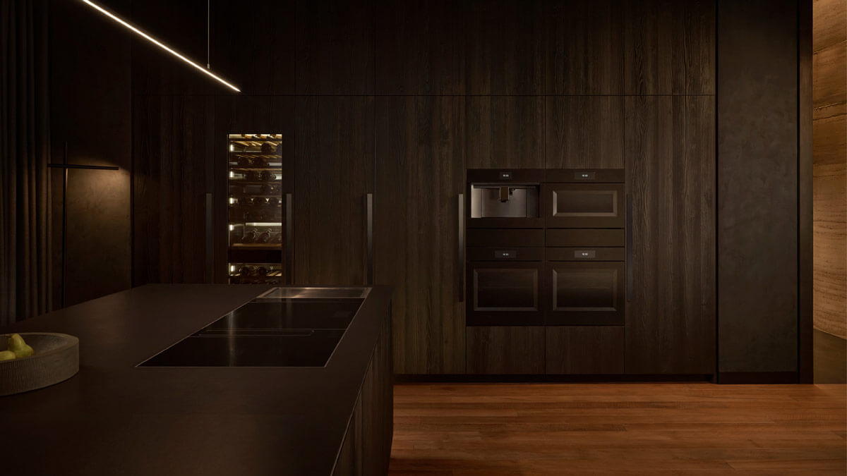 Luxury kitchen island with a wine column in the background dark cabinetry